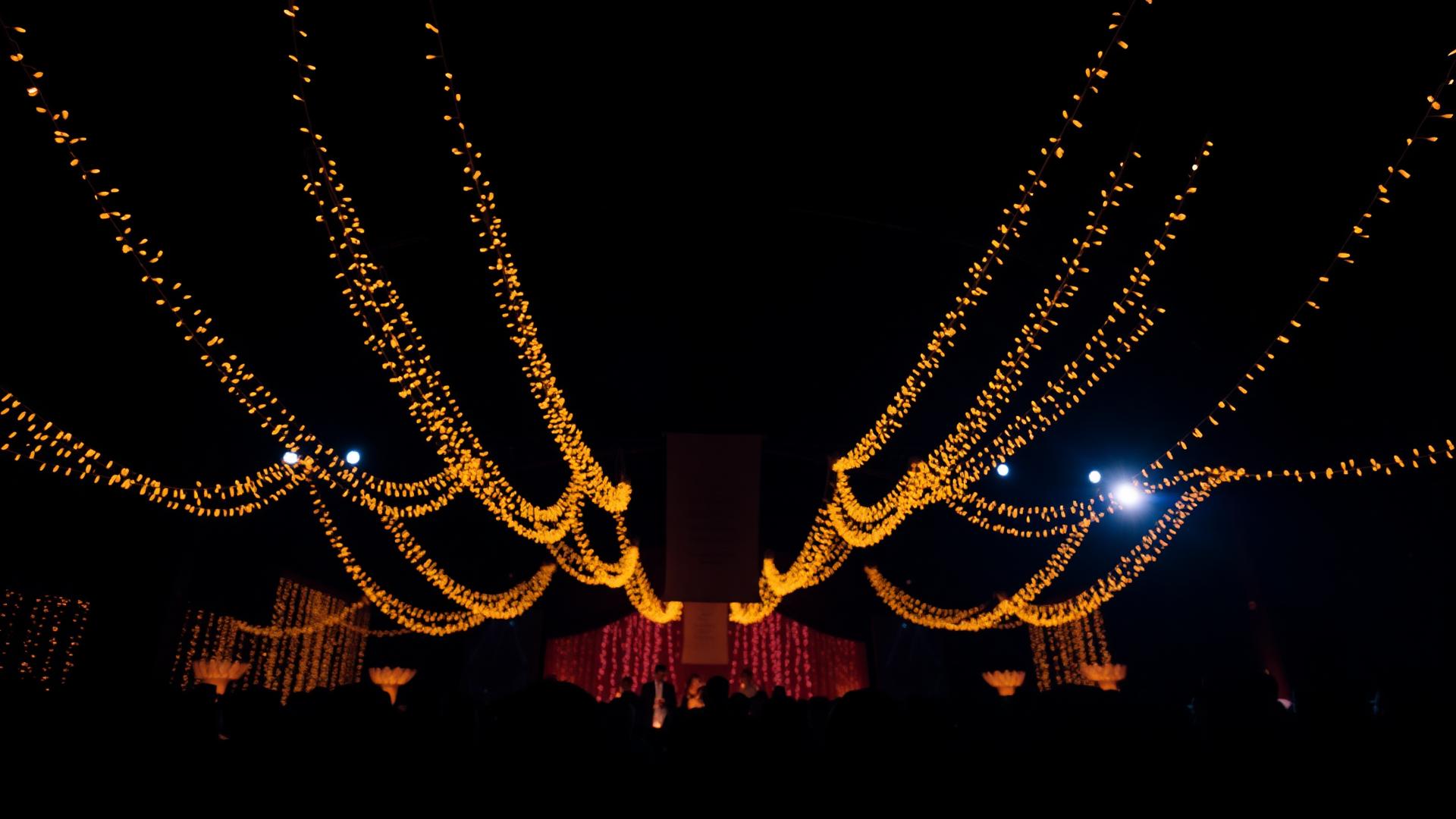 Luxury evening event hall glowing with golden string lights